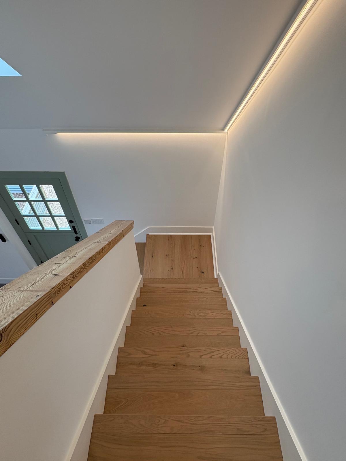 Oak staircase with cove lighting