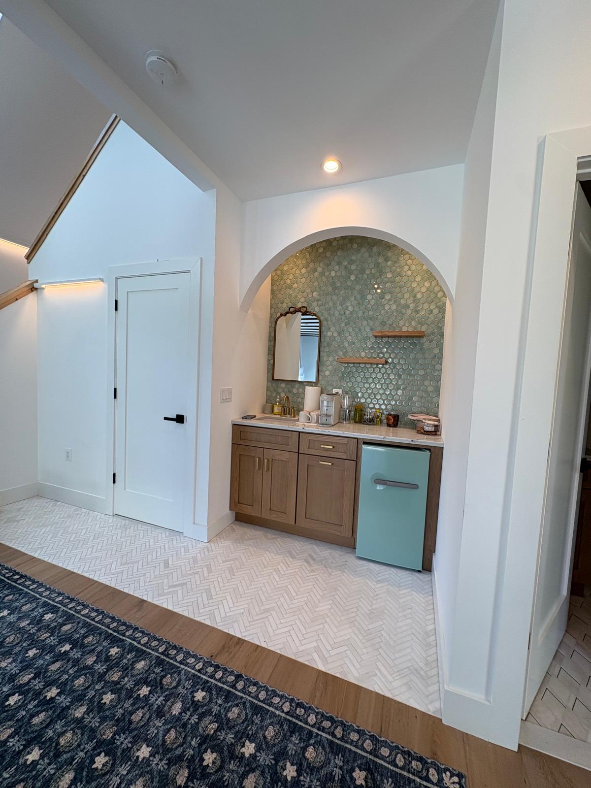 Hallway with bathroom and wet bar access